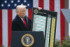 国・地域別の相互関税率の表を掲げるトランプ米大統領＝４月、ワシントン（ＡＦＰ時事）