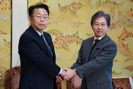 会談を前に握手する立憲民主党の安住淳幹事長(右)と公明党の西田実仁幹事長=16日午後、国会内
