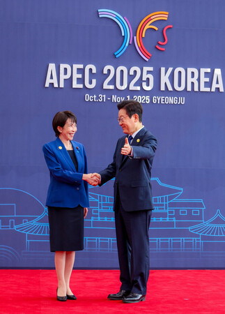 APEC首脳会議会場に到着し、韓国の李在明大統領(右)に迎えられる高市早苗首相=31日、韓国・慶州(内閣広報室提供・時事)