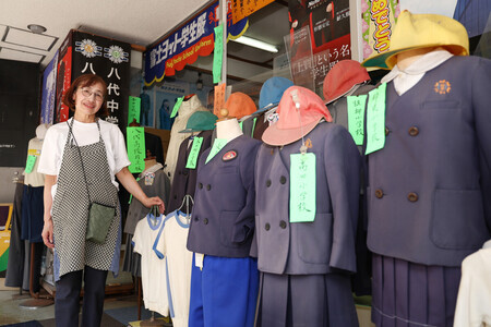 中心市街地の本町アーケード街で学生服を取り扱う「しょうの」を家族で営む庄野明子さん=27日午前、熊本県八代市