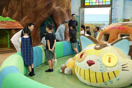 ジブリパーク内のネコバスルームを訪問し、地元の小学生と歓談される天皇、皇后両陛下=20日午前、愛知県長久手市(代表撮影)